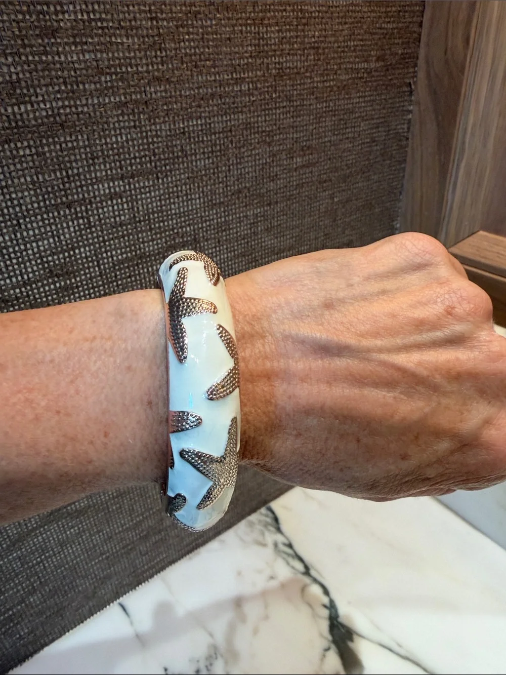 White enamel Bangle Bracelet with Textured gold tone Starfish Accents